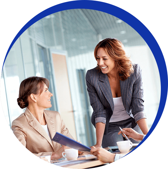 Two women are talking to each other in a room.