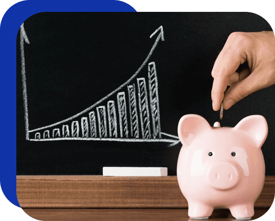 A piggy bank is being held up by someone with a hand on the chalkboard.